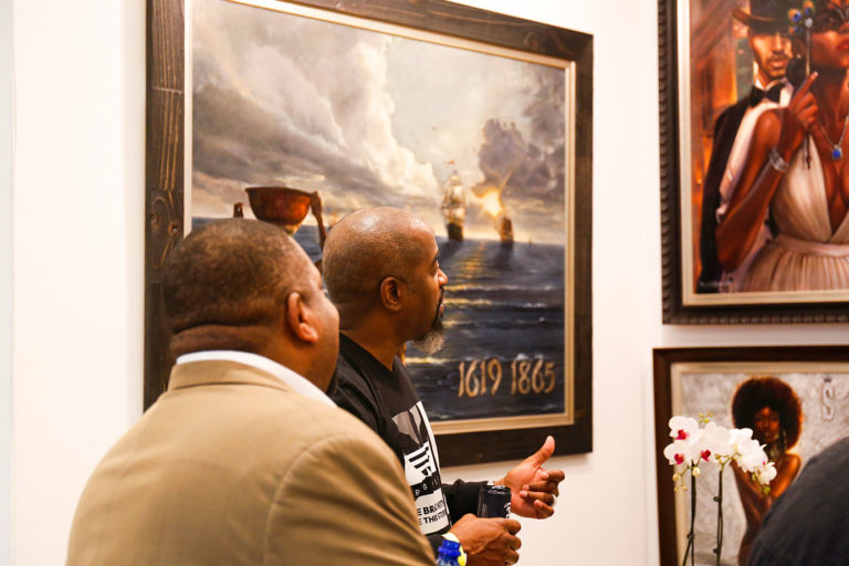 Kevin Williams explains his art to a guest