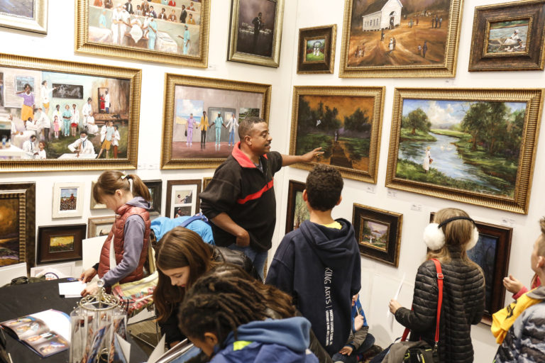 Artist Ted Ellis talks with local students about his art.