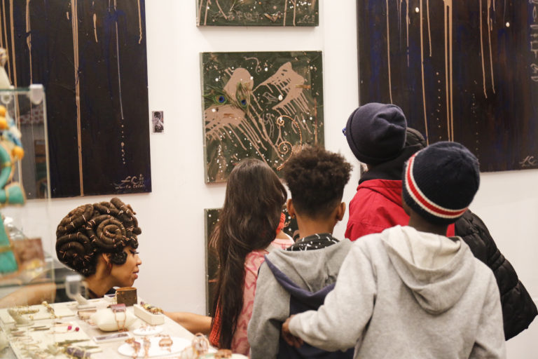 Local school kids take a tour of the showcase of diverse artists the 2017 Harlem Fine Arts Show.