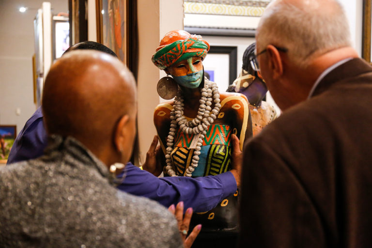Guests engaging with art at the Woodrow Nash exhibit